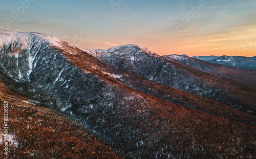 Snow covered peaks catch afternoon light in NH's White Mountains photo