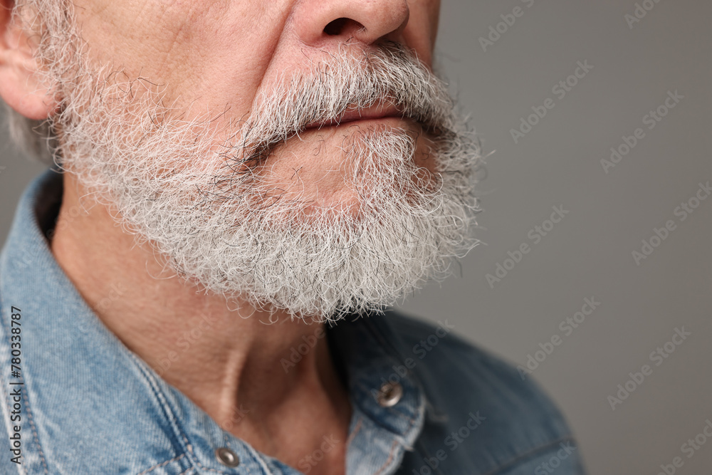 Obraz premium Man with mustache on grey background, closeup
