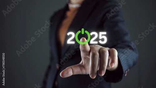 Businessman touching to virtual start button icon with 2025 for start merry Christmas and happy new year concept.