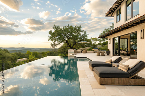 Luxurious home. Extravagant outdoor space with a spacious patio, infinity pool, lush landscaping, and stunning vistas. © Degimages