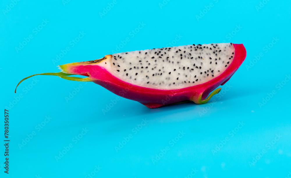 Dragon fruit in a section isolated on a blue background Dragon fruit in a section isolated on a blue background