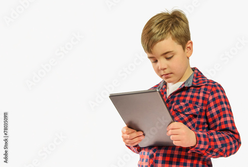 Boy 7-8 years old with a tablet, computer gadget on a white background, copy space