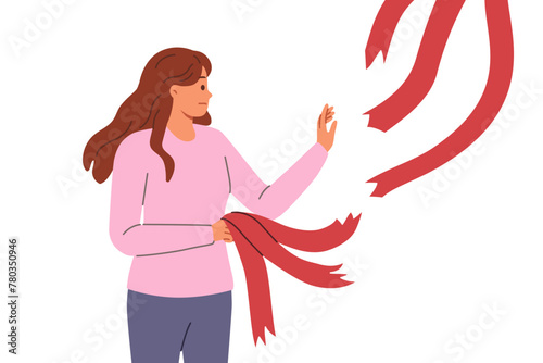 Woman breaking old ties in form of ribbons hanging from above, for concept of ending relationship with toxic friends. Breaking ties to get rid of narratives that negatively affect career growth