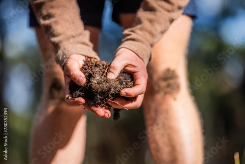 farmer hold soil in hands monitoring soil health on a farm. conducting soil tests