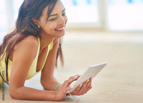 Free Download Young, woman and tablet on floor with happy for connectivity, streaming or online shopping. Female person, technology and smile for social media, e learning and gaming in chat or texting - GFXLoad