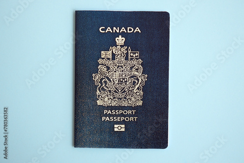 Canadian passport on blue background close up. Tourism and citizenship concept © mehaniq41