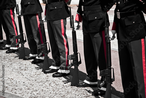 A display of uniformity and discipline, soldiers stand at attention in formation with rifles at a public event photo
