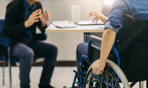 After accident and rehabilitation, a disabled man can return to work with wheelchair. Company which job hiring employing disabilities people will receive tax deductions benefits.