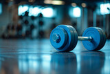 Closeup of blue barbell dumbbell weight on the floor in gym