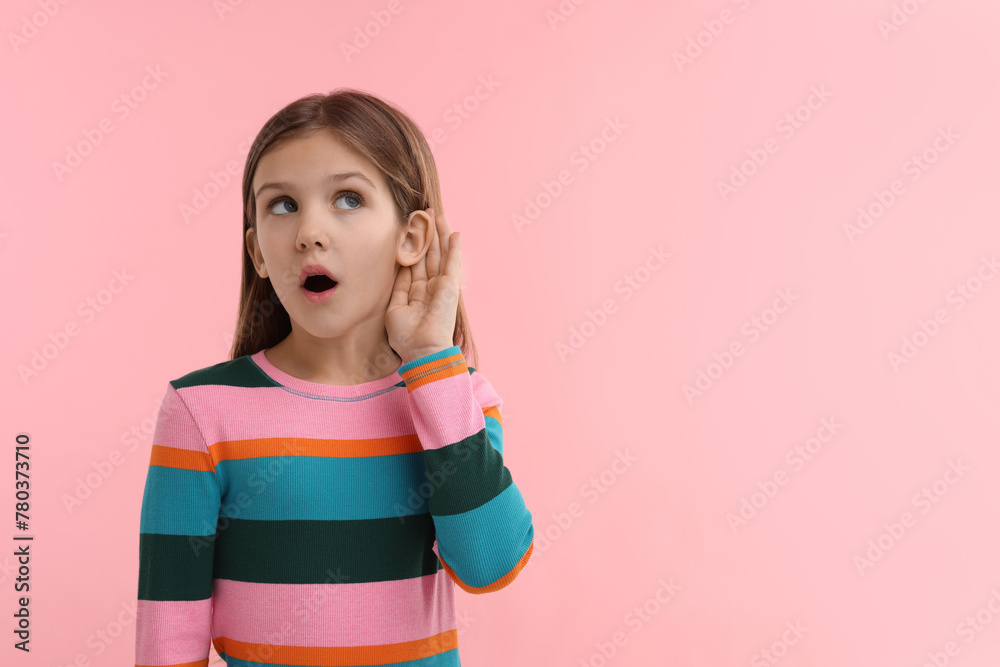 Little girl with hearing problem on pink background, space for text Little girl with hearing problem on pink background, space for text