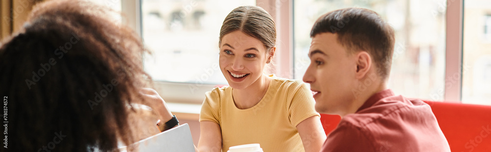 A group of students from various backgrounds sit around a table, engaged in a lively discussion. A group of students from various backgrounds sit around a table, engaged in a lively discussion.
