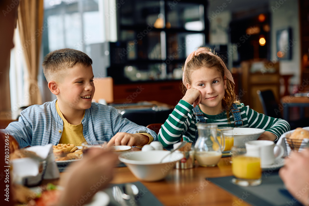 Happy kids enjoying in family breakfast in restaurant at hotel. Happy kids enjoying in family breakfast in restaurant at hotel.