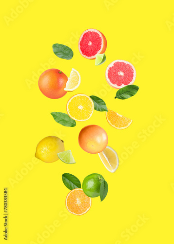 Fototapeta Naklejka Na Ścianę i Meble -  Many different fresh citrus fruits falling on yellow background