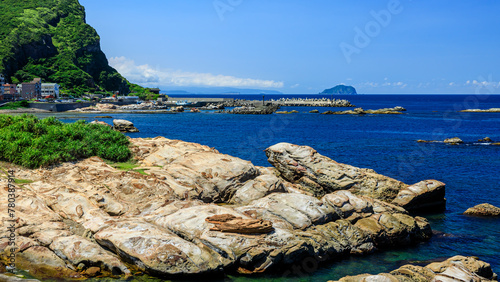 Peculiar rocks in forms of a seal and a Flip Flop at Nanya of Rueifang District in New Taipei City, Northeastern Taiwan, a unique geological landscape formed by coastal erosion of sedimentary rocks. photo