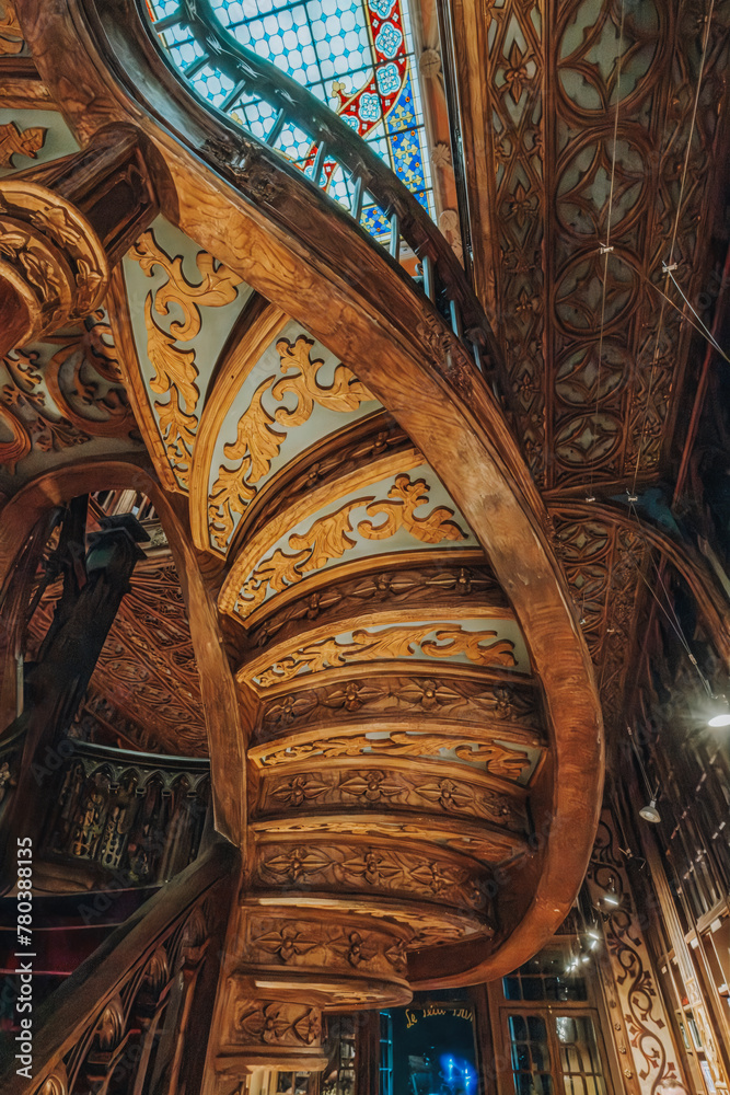 Fototapeta premium Porto, Portugal - October 30, 2023: Interior view of Lello bookstore (Portuguese: Livraria Lello) and its famous wooden staircase in historic center of Porto , famous for Harry Potter film (Porto)
