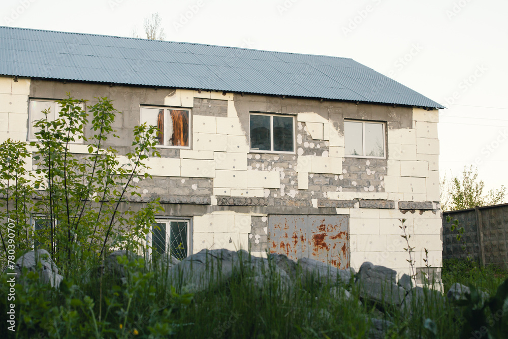 An old semi-ruined building with a large metal gate