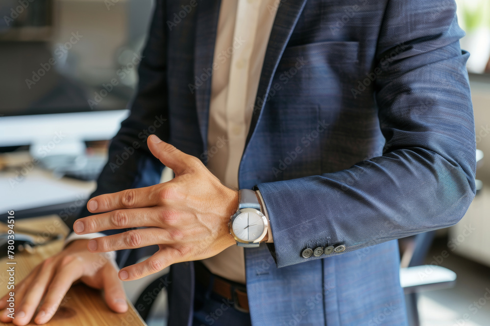 Businessman suffering from wrist pain at his workspace