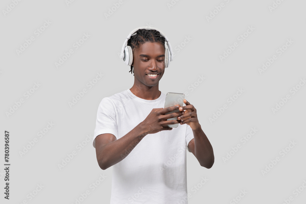 Man enjoying music on smartphone and headphones Man enjoying music on smartphone and headphones