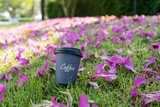 Cup of coffee in the green grass.