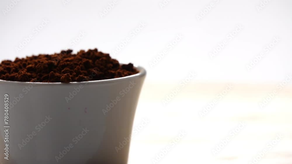 Gyration instant coffee in a white glass bowl on a wooden table.