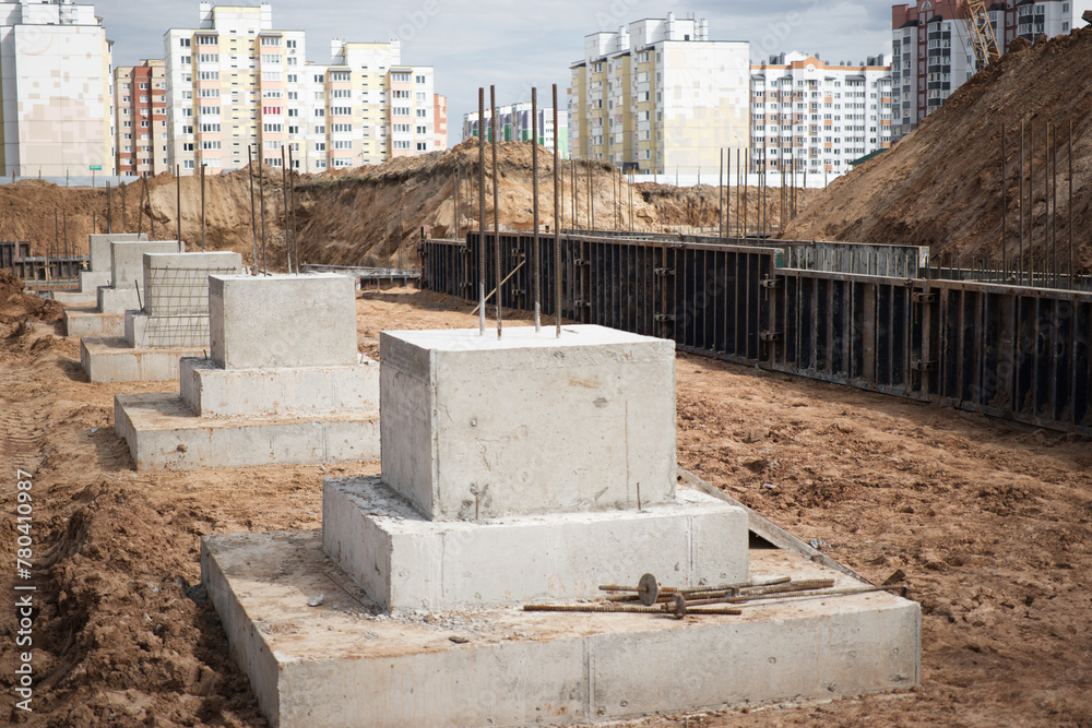 A row of cement blocks stand tall on a dirt field, laying the groundwork for future construction projects at a site