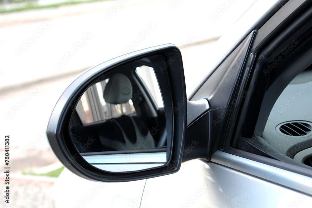 Close-up of the black side mirror of the car. Car mirror with blind spot warning. Car Mirror Cover Rearview Mirror.