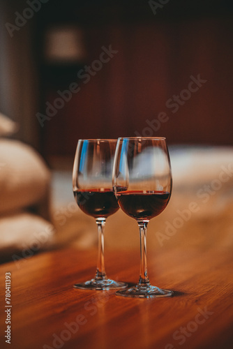 Two glasses filled with red wine, in a cozy apartment 