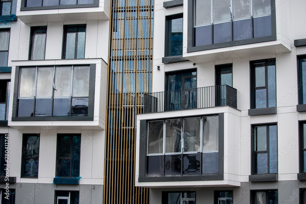 Obraz premium Modern townhouses in a residential area with multiple new apartments buildings surrounded by green outdoor facilities in central calm neighborhood