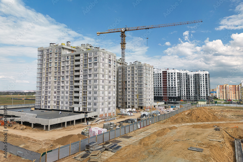 A bustling construction site with workers in hard hats, machinery moving materials, and a towering crane in the background overseeing the building process A bustling construction site with workers in hard hats, machinery moving materials, and a towering crane in the background overseeing the building process