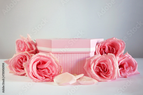 Product podium placement with pink roses flowers on grey background, Empty podium with rose and petals for display gifts, products or cosmetics