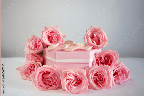 Product podium placement with pink roses flowers on grey background, Empty podium with rose and petals for display gifts, products or cosmetics