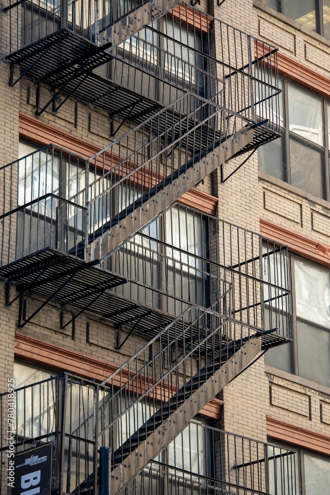 Vertical shot of a fire escape staircase of a brick building in New York, United States. Vertical shot of a fire escape staircase of a brick building in New York, United States.