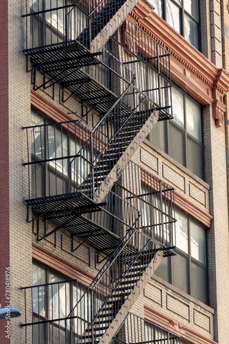 Vertical shot of a fire escape staircase of a brick building in New York, United States.