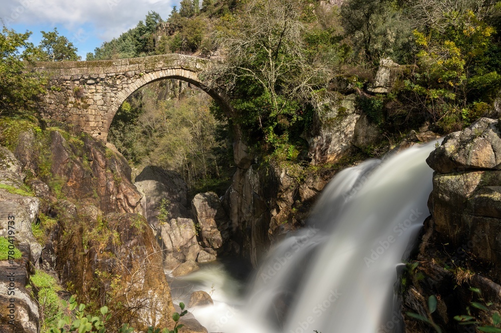 Bridge of Mizarela in Portugal with rich vegetation around crossing Rabagao river below Bridge of Mizarela in Portugal with rich vegetation around crossing Rabagao river below