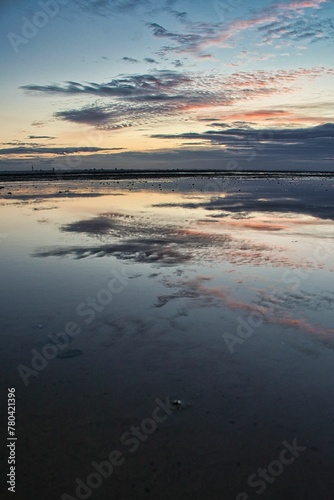 Vertical shot of a seascape with a beautiful sunset in the background © Wirestock
