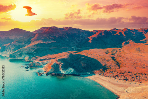 Aerial view of Rocky seashore with dramatic sunset sky. Seascape in the evening. Cabo de Gata-Níjar reserve. Almeria, Andalusia, Spain