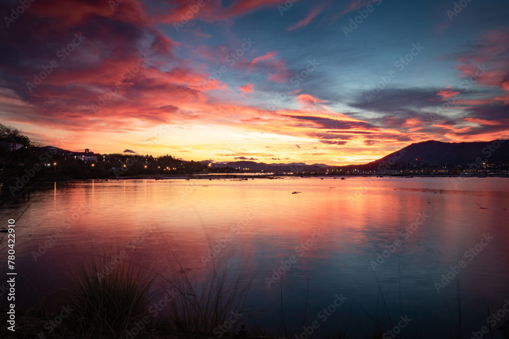 scenic sunset with clouds in winter over txingudi bay in hendaye