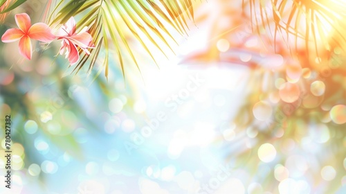 Beautiful summer background with copy space and blurred background with bokeh. Sea, palm leaves and flowers in the light of the bright summer sun. © SerPhoto