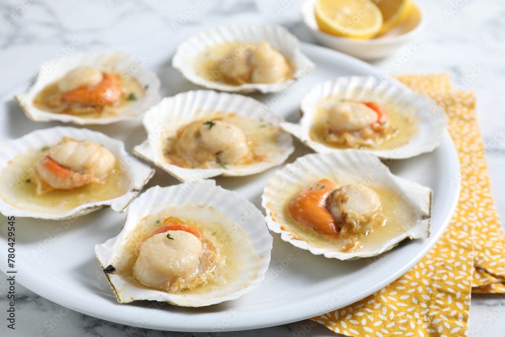 Fried scallops in shells on white marble table, closeup Fried scallops in shells on white marble table, closeup