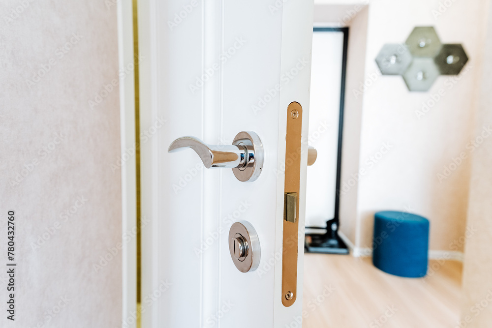 Door lock on white door, door locking mechanism, apartment interior, private hallway house. Door lock on white door, door locking mechanism, apartment interior, private hallway house.