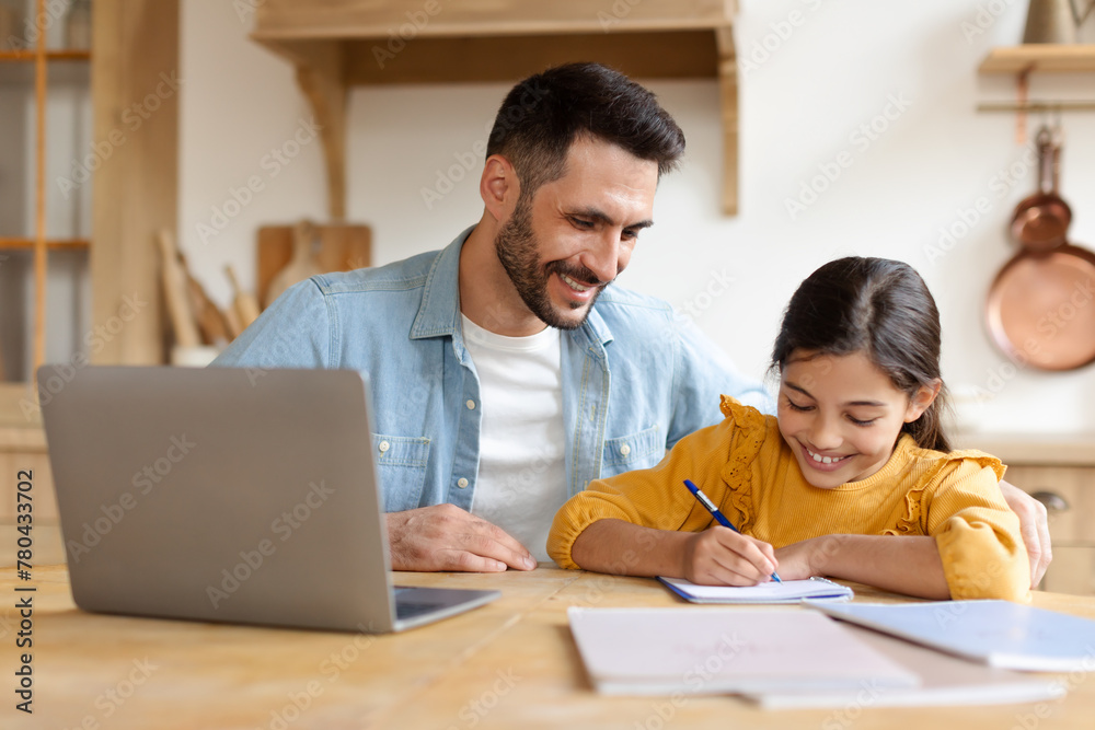 Man helping young girl with homework at home Man helping young girl with homework at home