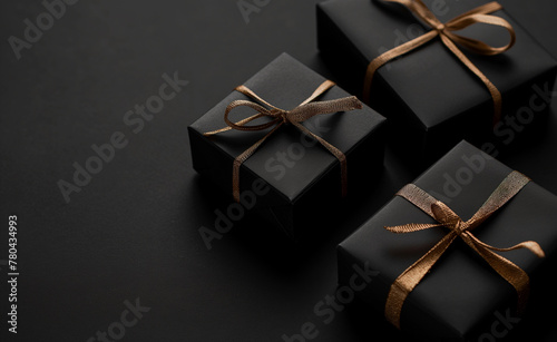 Black gift boxes on a black background. © Curioso.Photography