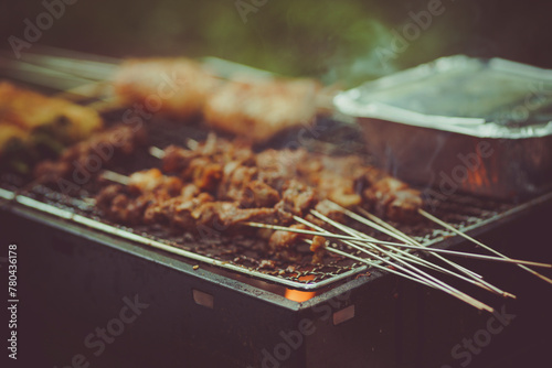 Closeup shot of meat on sticks being barbecued on a brazier