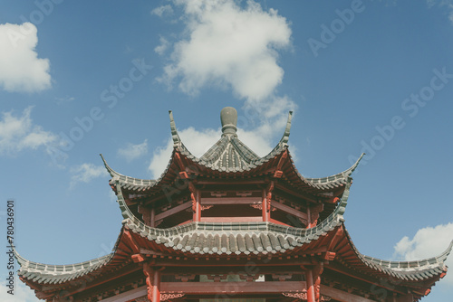 Top of an Asian building against the blue cloudy sky