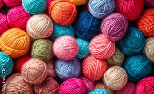 Vivid Fibers: Close-up of Colorful Wool Balls on Textured Background