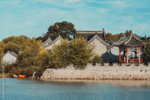 Beautiful view of a Chinese pavilion by the lake with trees