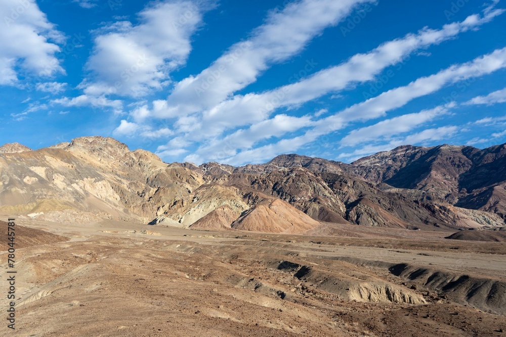 Dramatic shot of striped clouds over mountain ridge in Death Valley on a sunny day Dramatic shot of striped clouds over mountain ridge in Death Valley on a sunny day