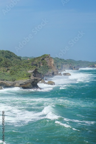 Aerial view of sea waves breaking rocky beach