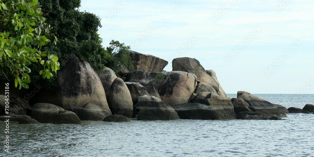 Panoramic view of the big rocks on the beach