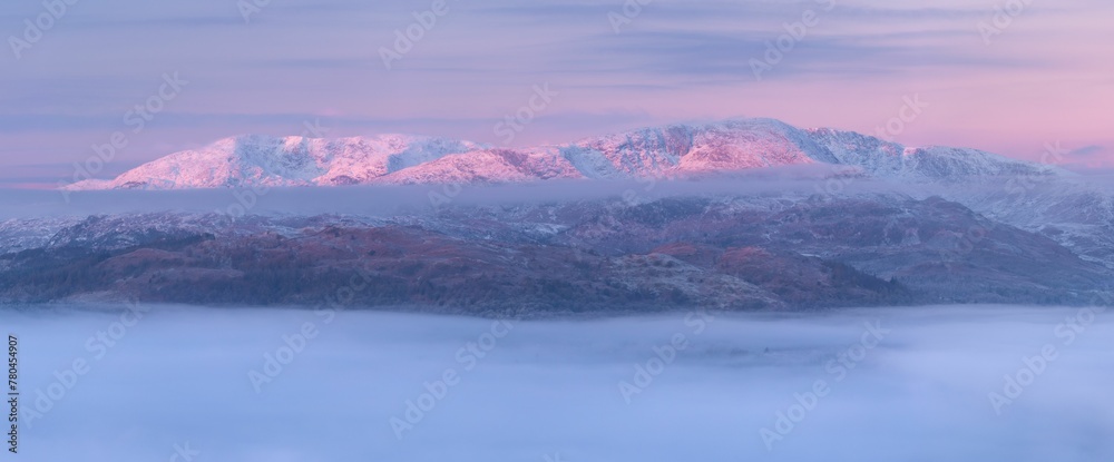 Winter landscape view at sunrise with frozen mountain, snow around